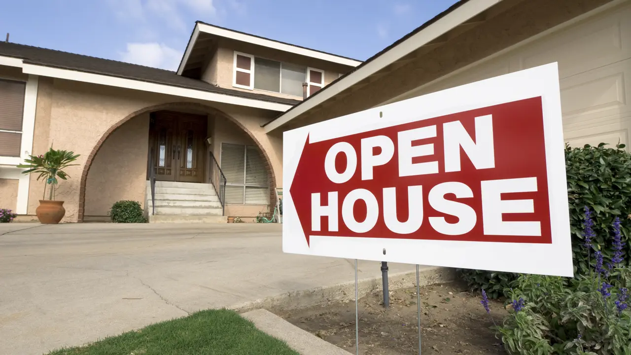 A home with an open house sign in front.
