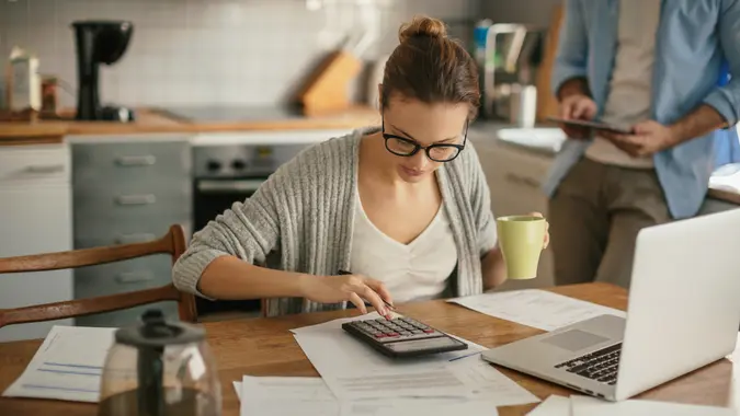 young woman using calculator