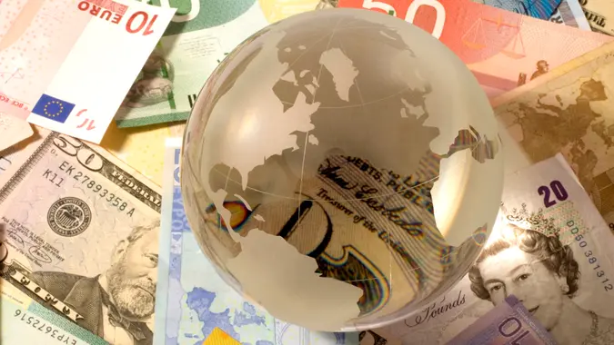 Glass globe on variety of banknote.