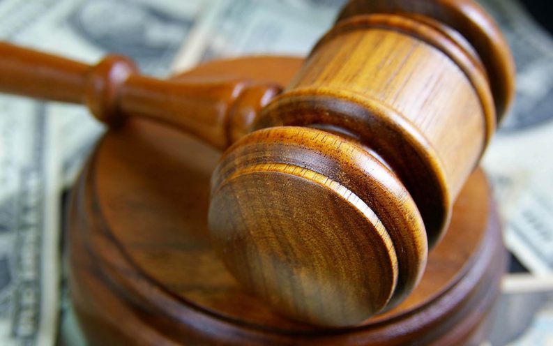 gavel around pile of cash gavel around pile of cash