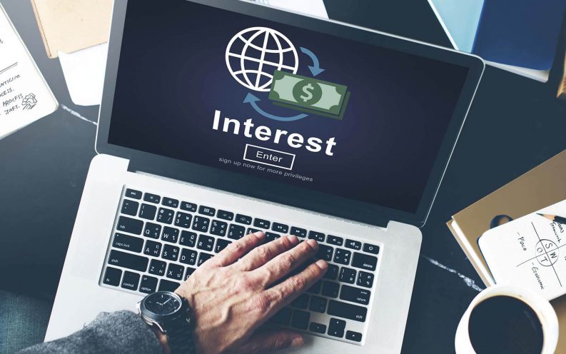 computer check interest rates take notes coffee computer check interest rates take notes coffee