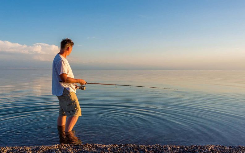 man fishing water blue man fishing water blue