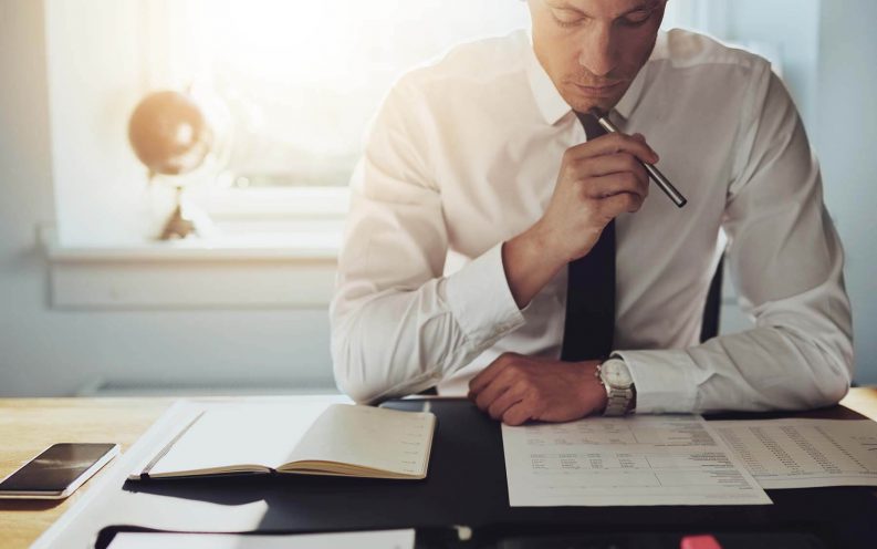 man in suit reading taking notes work man in suit reading taking notes work