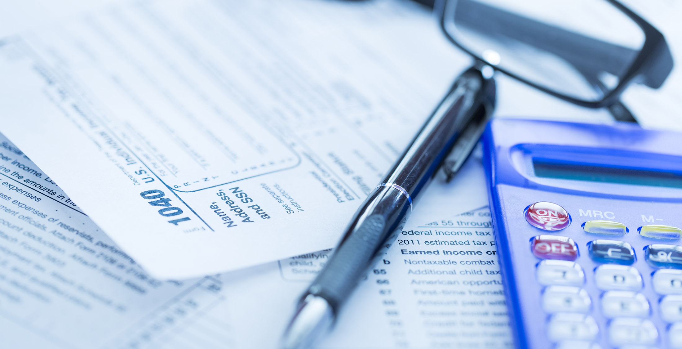 Taxes and monetary policy 1040 form with pen calculator