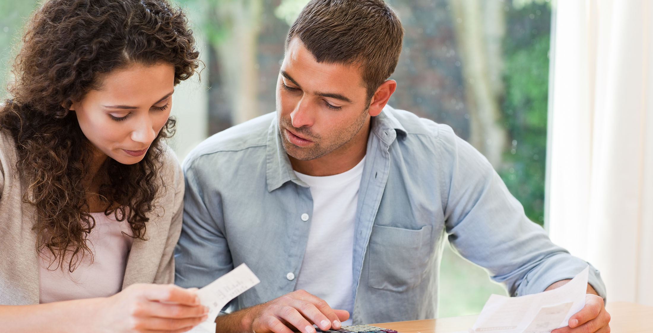 Gather all of your bills and receipts. couple looking over financial statements