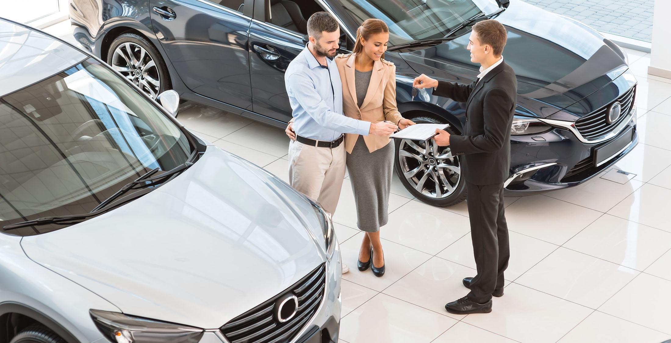 couple signing new car lease