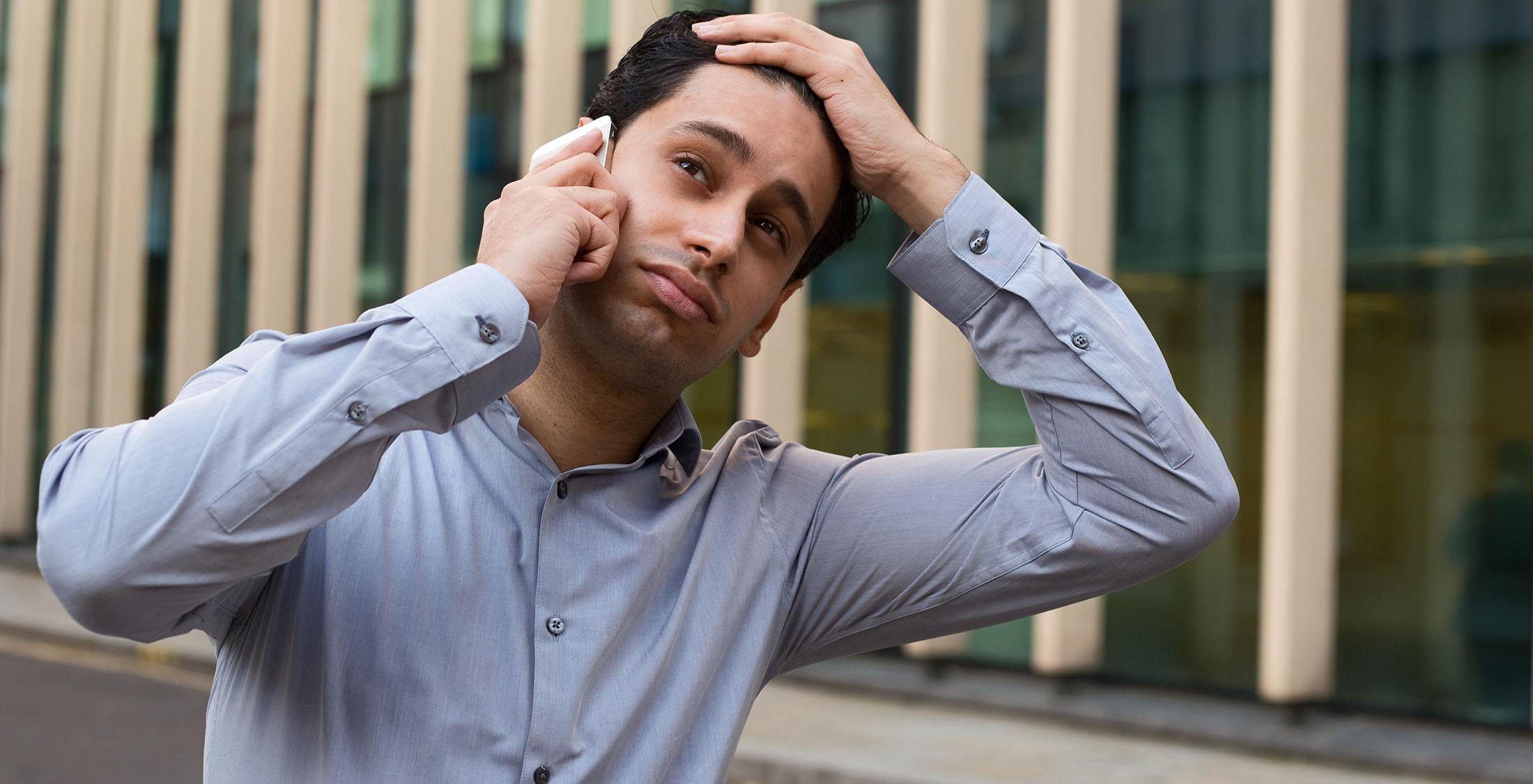 man frustrated on phone call