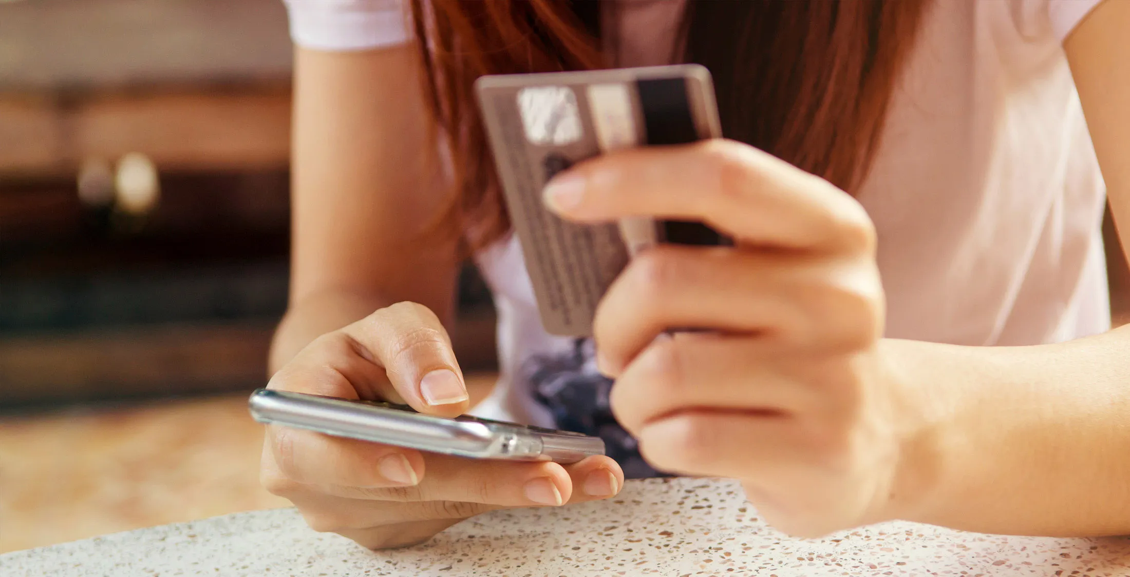 girl paying with credit card on mobile cell phone mobile banking