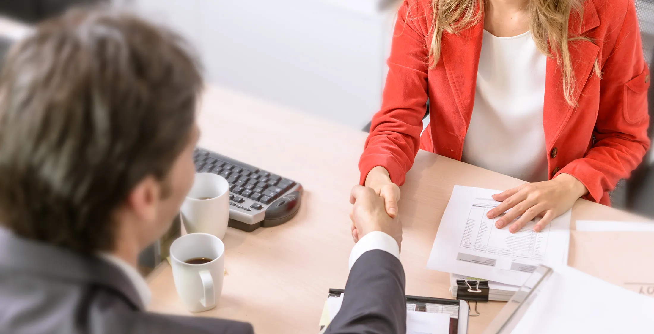 male and female business people shaking hands