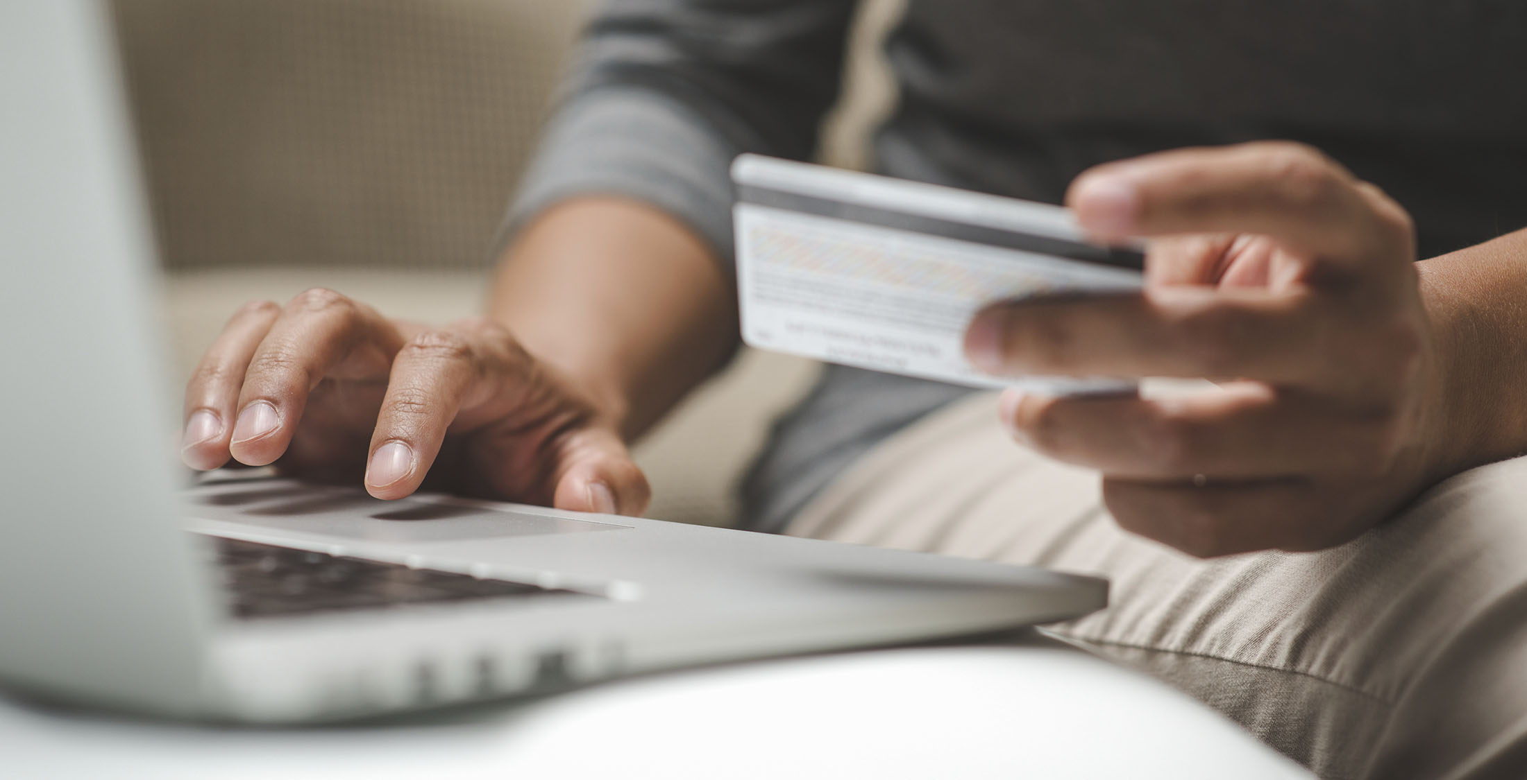 You're paying the minimum on your debts. Internet shopper entering credit card information using laptop keyboard