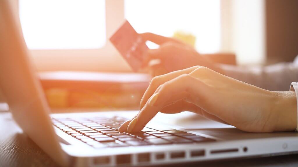 Pay All Your Current Bills for the Month person using computer