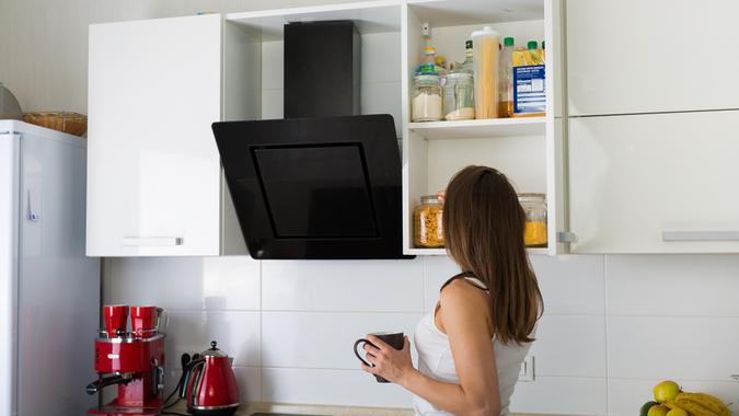 Woman  preparing a breakfast at her kitchen in the morning.