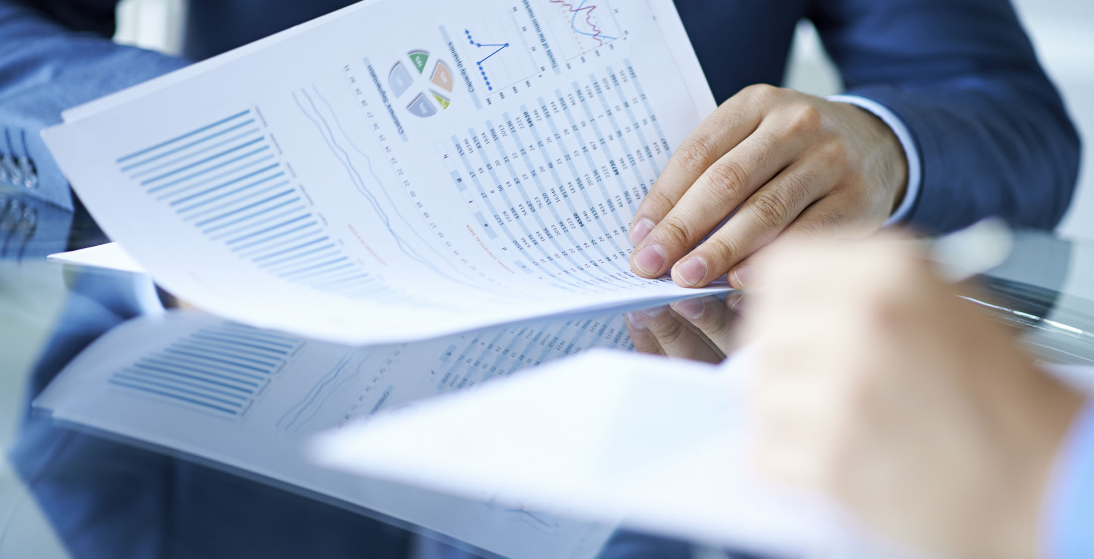 You fail to think like an investor. Hands of businessman examining financial report
