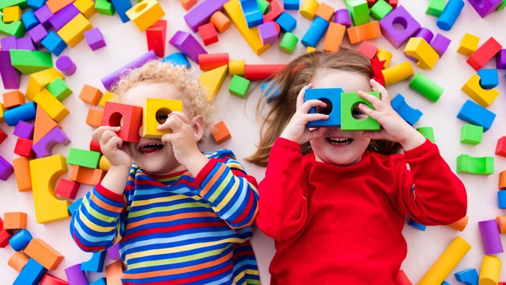 Toys children laying down with blocks