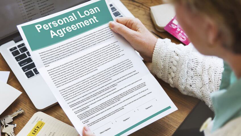woman reading a personal loan agreement contract