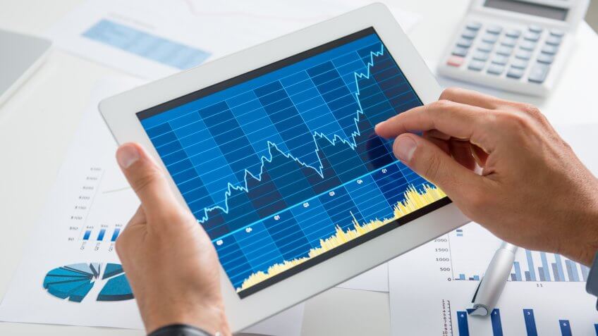 man reviewing a chart on his smart tablet ipad