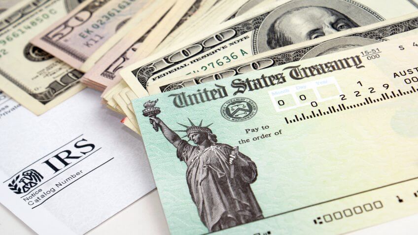 stack of cash with a treasury bond on top
