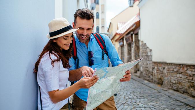 vacationing couple looking at a map