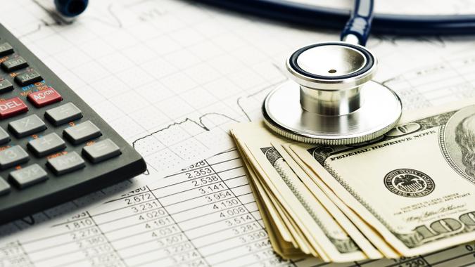 cash, a calculator and a stethoscope