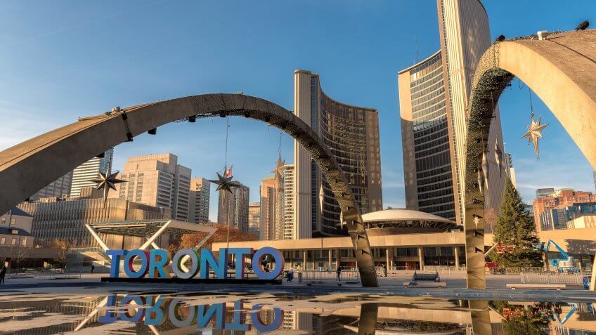Canada., How Much to Tip When Traveling to These 25 Countries, Toronto City Hall on Nathan Phillips Square at sunset
