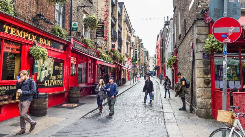 2016: Tourists walking in the Temple Bar area. The place is the , DUBLIN, How Much to Tip When Traveling to These 25 Countries, IRELAND - 05 MAY, bars and nightclubs.