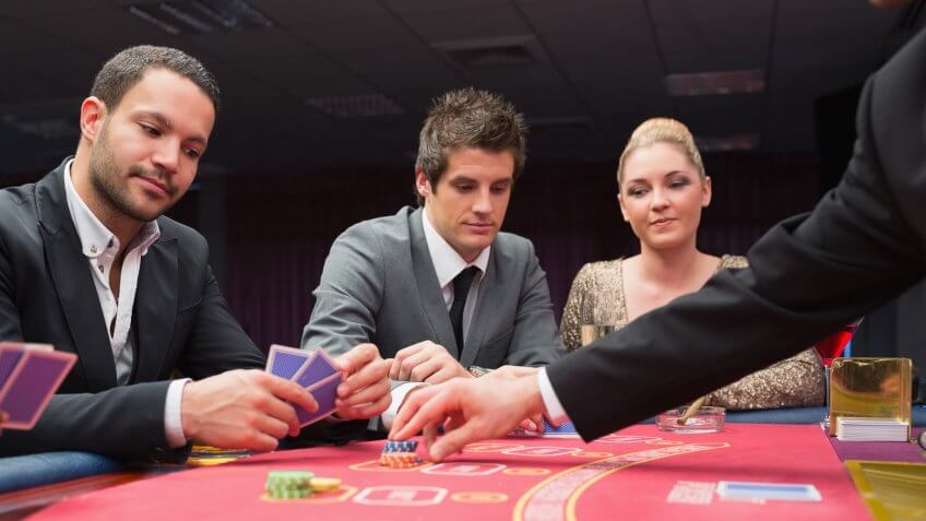 Two men and one woman playing poker