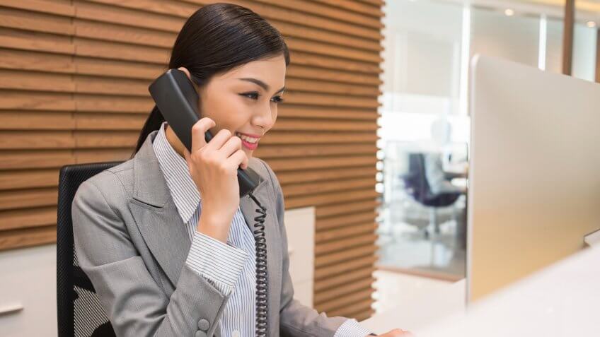 Woman in office answering a phonecall