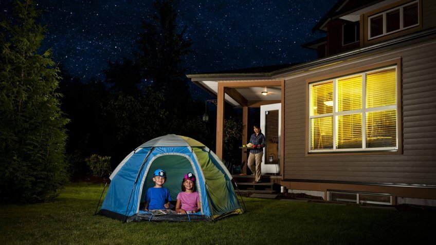 kids camping in the backyard in a tent