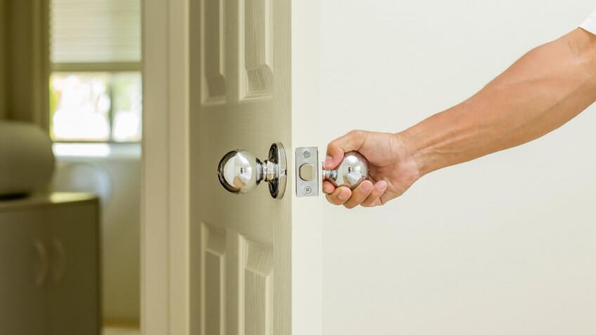 hand holding a doorknob