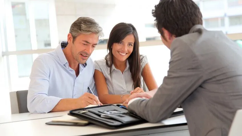 man and woman signing contract