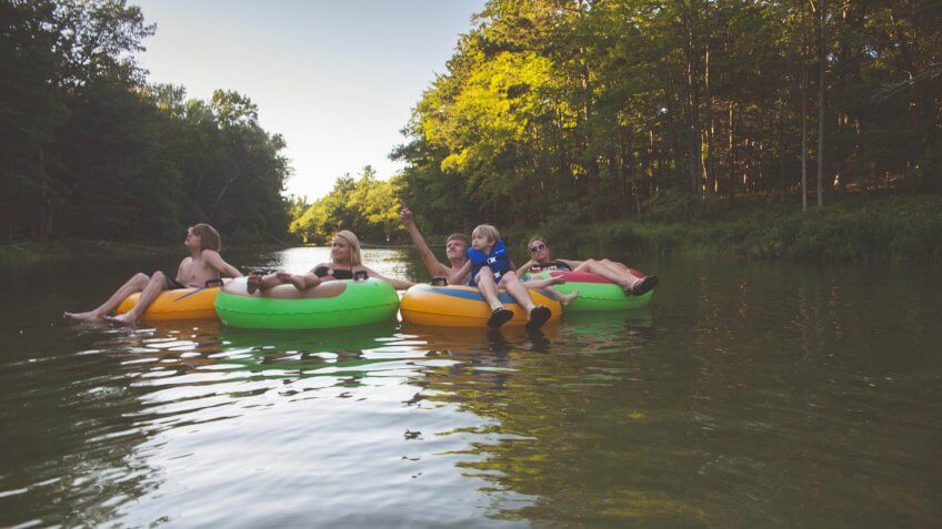 group of friends floating down a river