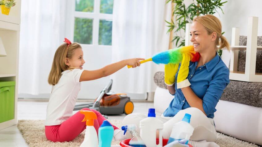 mother cleaning the house with daughter