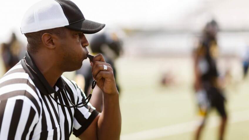 referee blowing a whistle