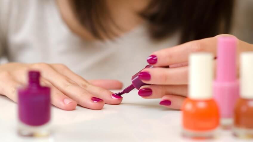 woman painting her own fingernails