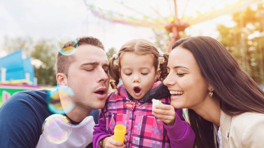 family blowing bubbles at a fair