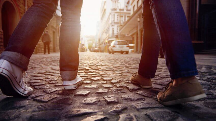 walking down a cobblestone street