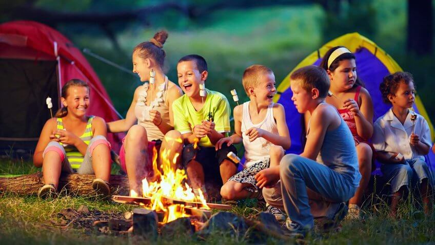 kids' summer camp around a fire