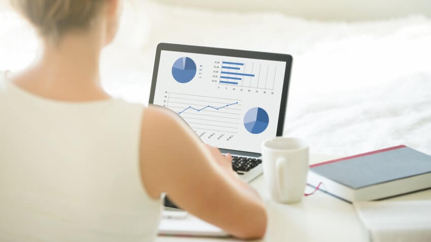 woman looking at investment portfolio on laptop screen