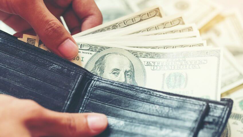 withdrawing cash from a wallet