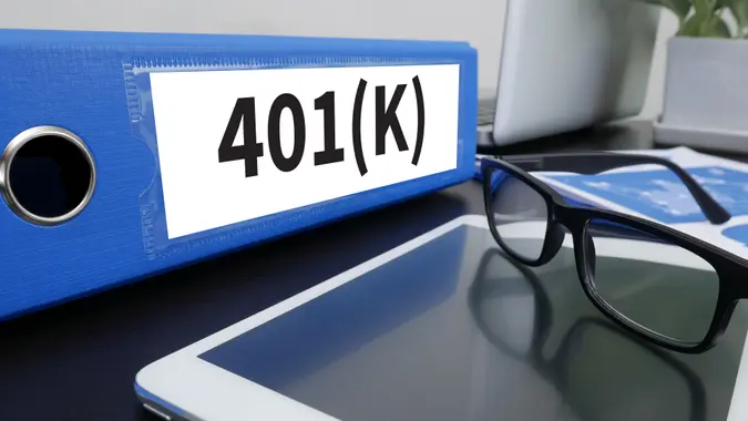 401K binder with glasses and tablet