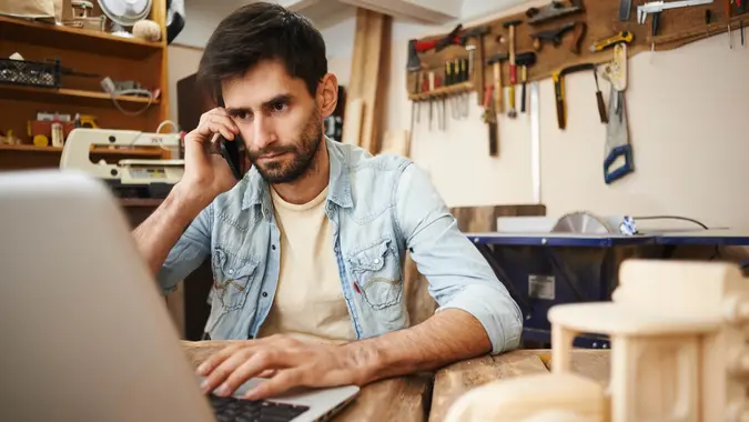Man on phone and laptop doing business.