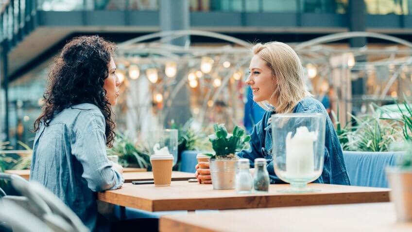 Two women drinking coffee at a cafe