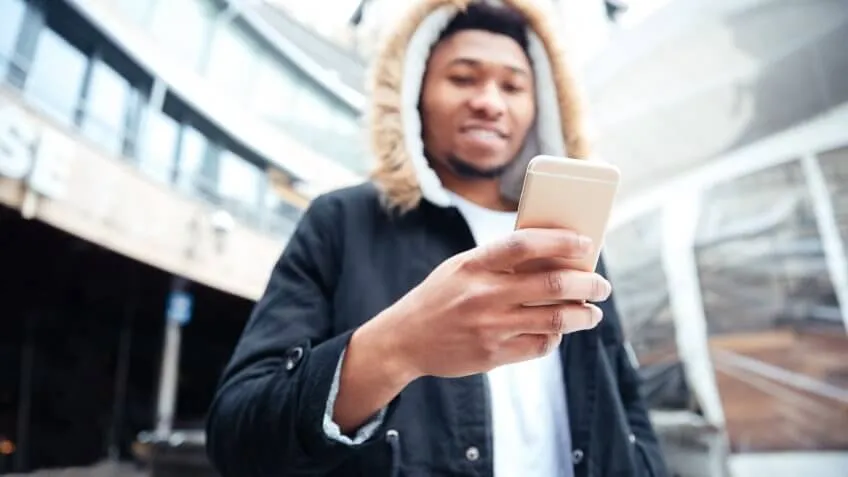 Man smiling checking his smart phone