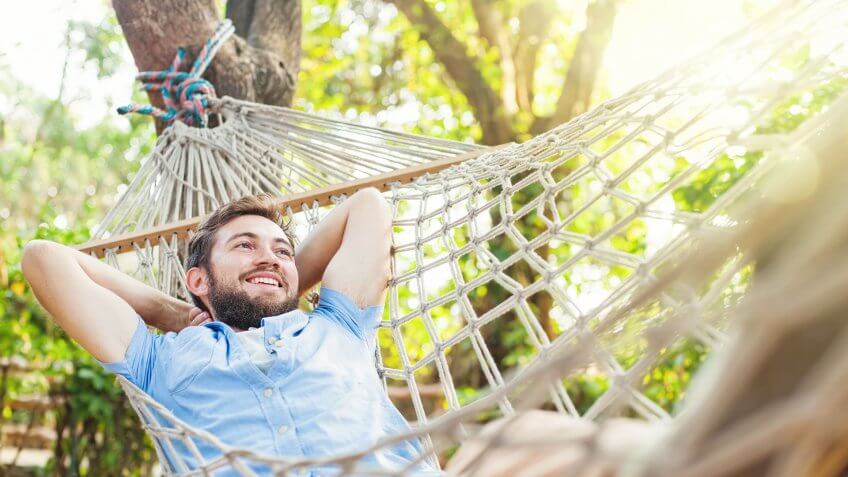 man relaxing in hammock