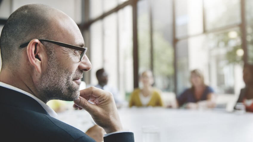 businessman smiling and looking at something offscreen