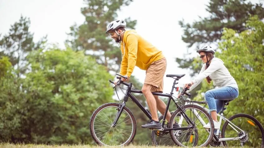 man and woman biking in nature outdoors