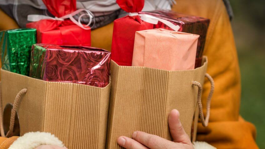 person holding wrapped presents