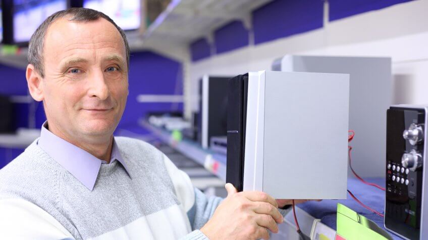 man holding speaker in store