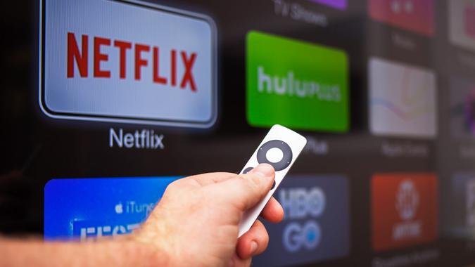 Las Vegas, USA - October 24, 2014: A man in his 30's browsing the channel selections on Apple TV at his home in Las Vegas.