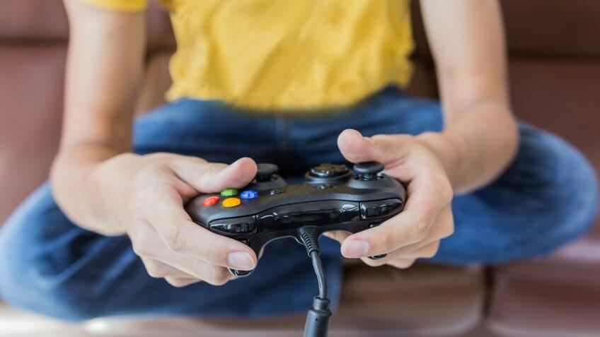kid holding video game console